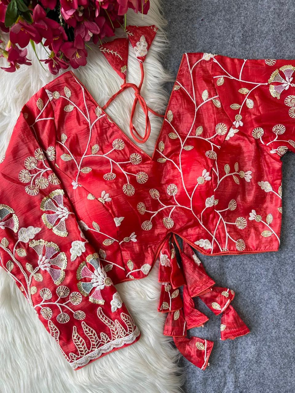 Red blouse with floral vine embroidery and decorative tie tassels