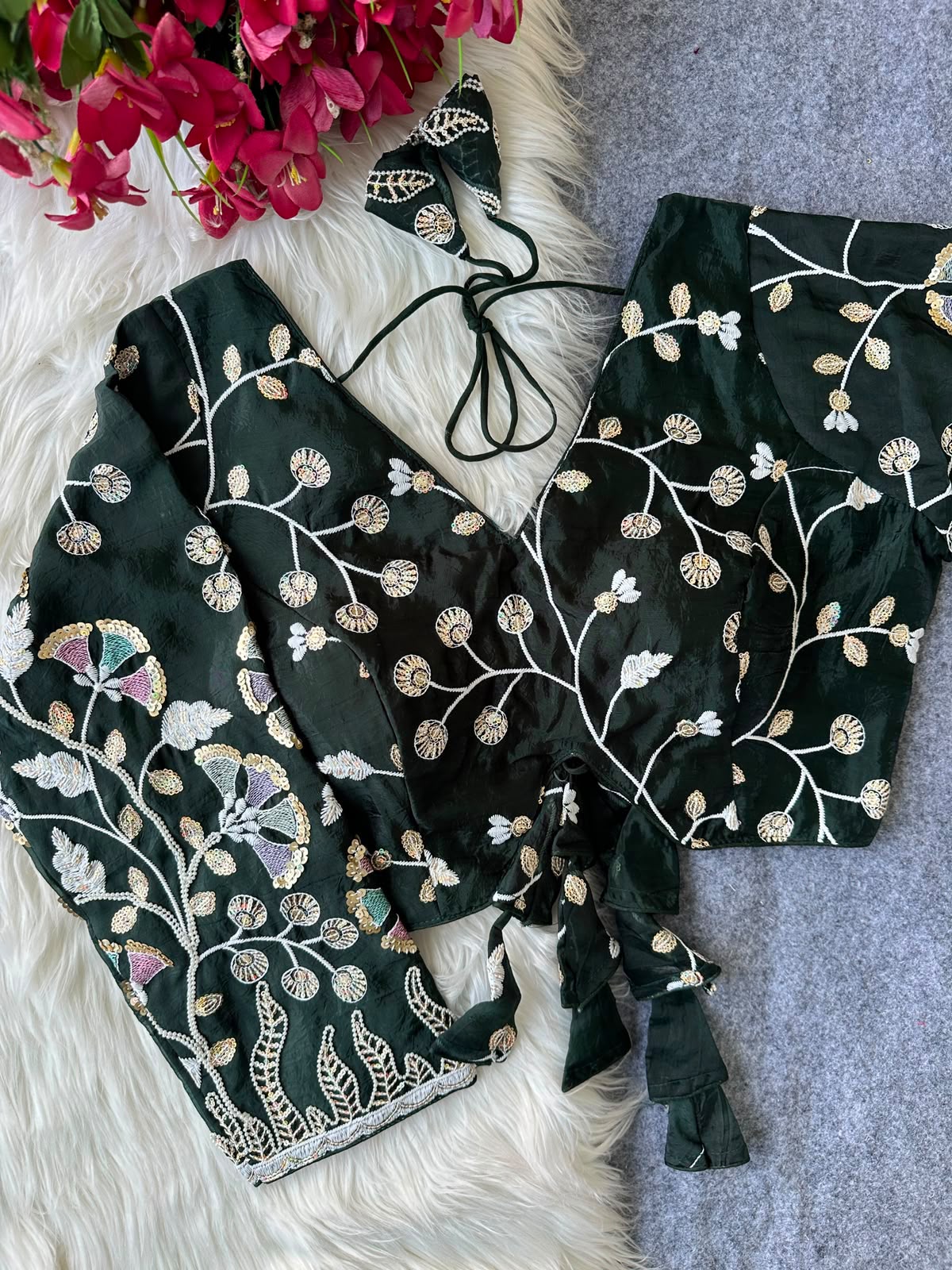 Green blouse with floral vine embroidery and decorative tie tassels