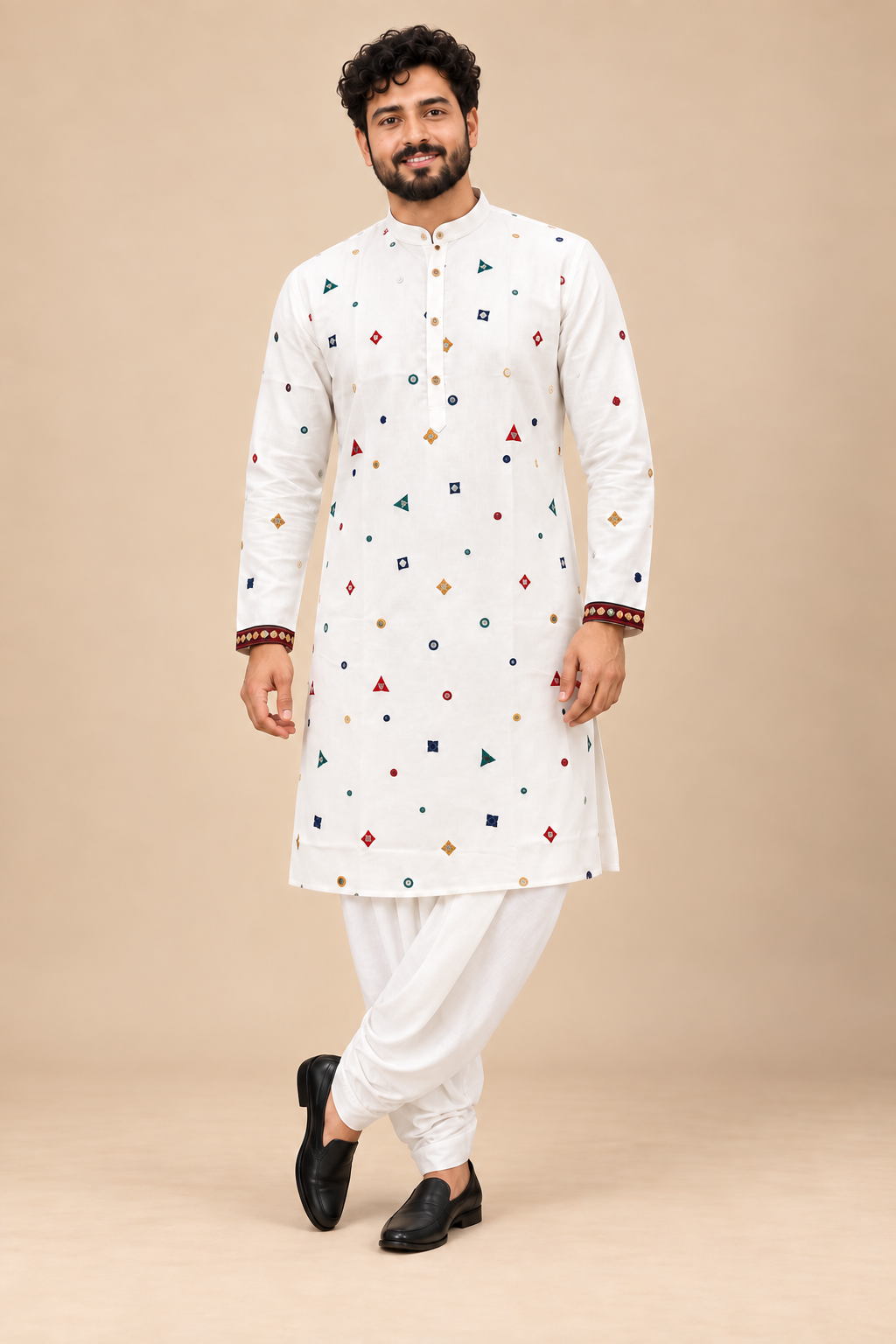 Indian model wearing white embroidered kurta and white stitched dhoti with diagonal draping on a beige background