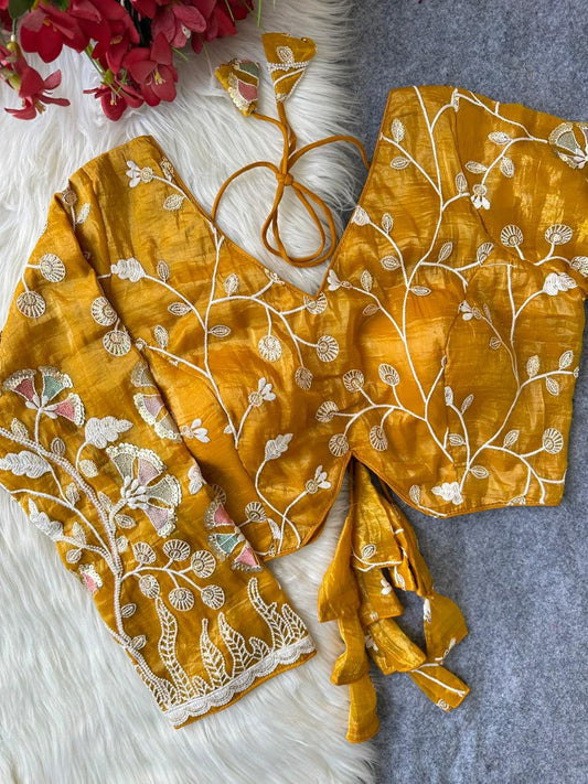 Yellow blouse with floral vine embroidery and decorative tie tassels